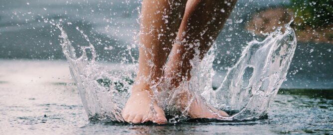 water splashing on a persons feet